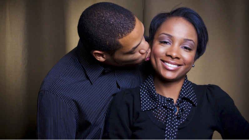 husband kissing wife on cheek