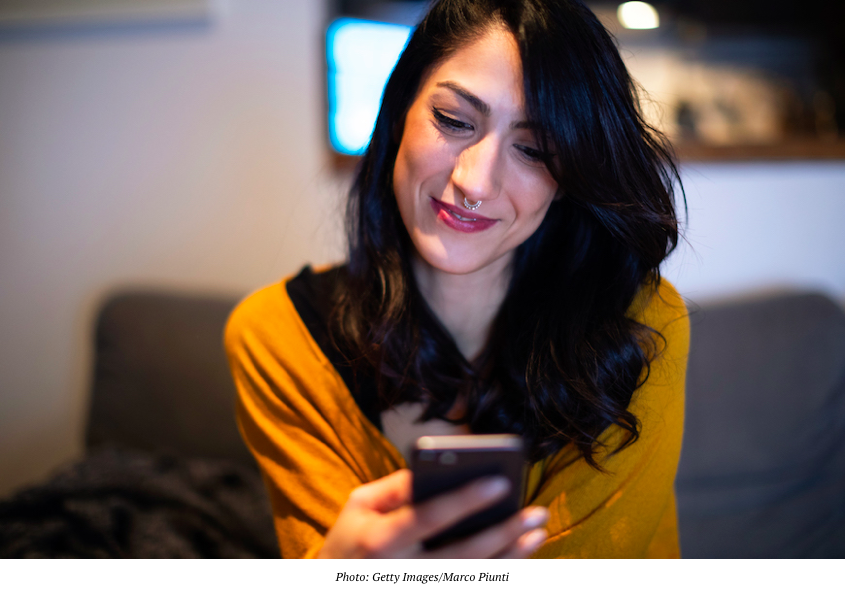 Girl writing pick opening line on dating app